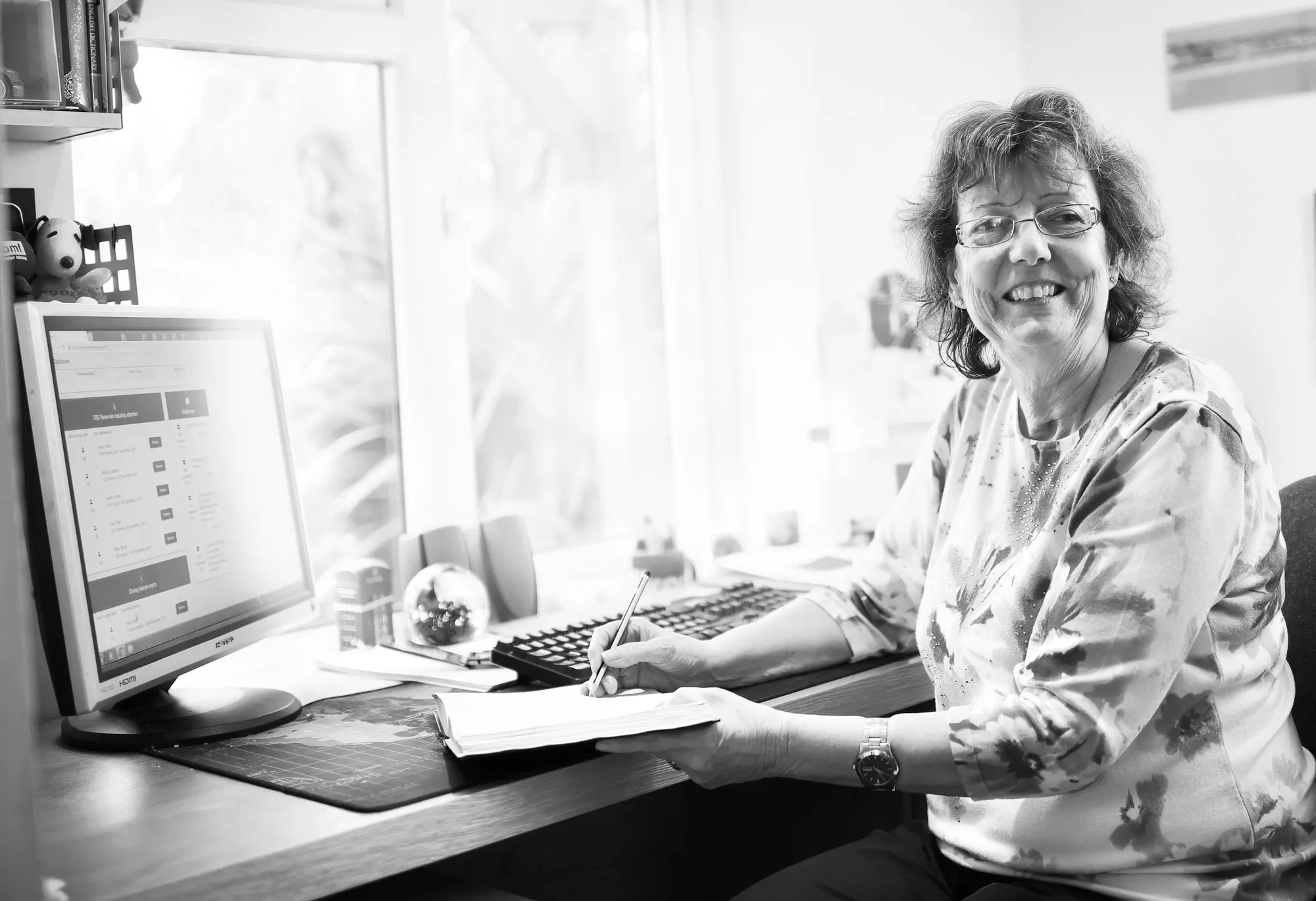Lizzie at her desk, with Via open on the screen beside her.